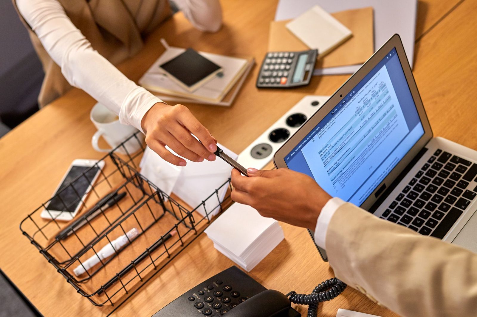 Two professionals reviewing controlled documents together in an office setting
